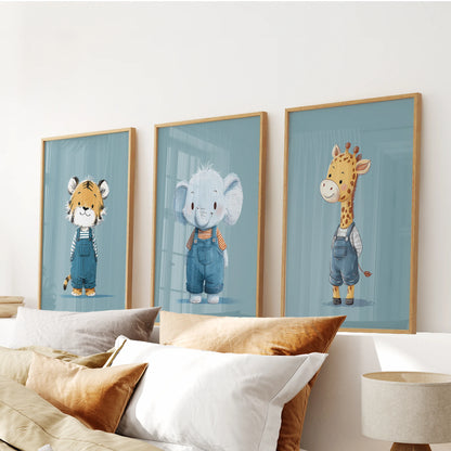 Jungle animal wall prints in natural oak frames form a warm three-piece arrangement above the bedroom headboard in gentle blue tones.