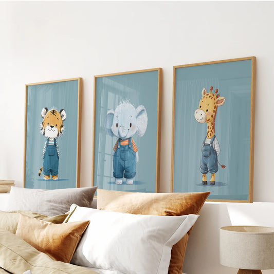 Jungle animal wall prints in natural oak frames form a warm three-piece arrangement above the bedroom headboard in gentle blue tones.