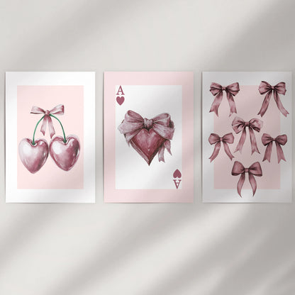 Coquette pink icon trio 3-piece poster set-ace of hearts, bows, and cherries-arrives as unframed rolled prints for a clean look on a minimal wall.