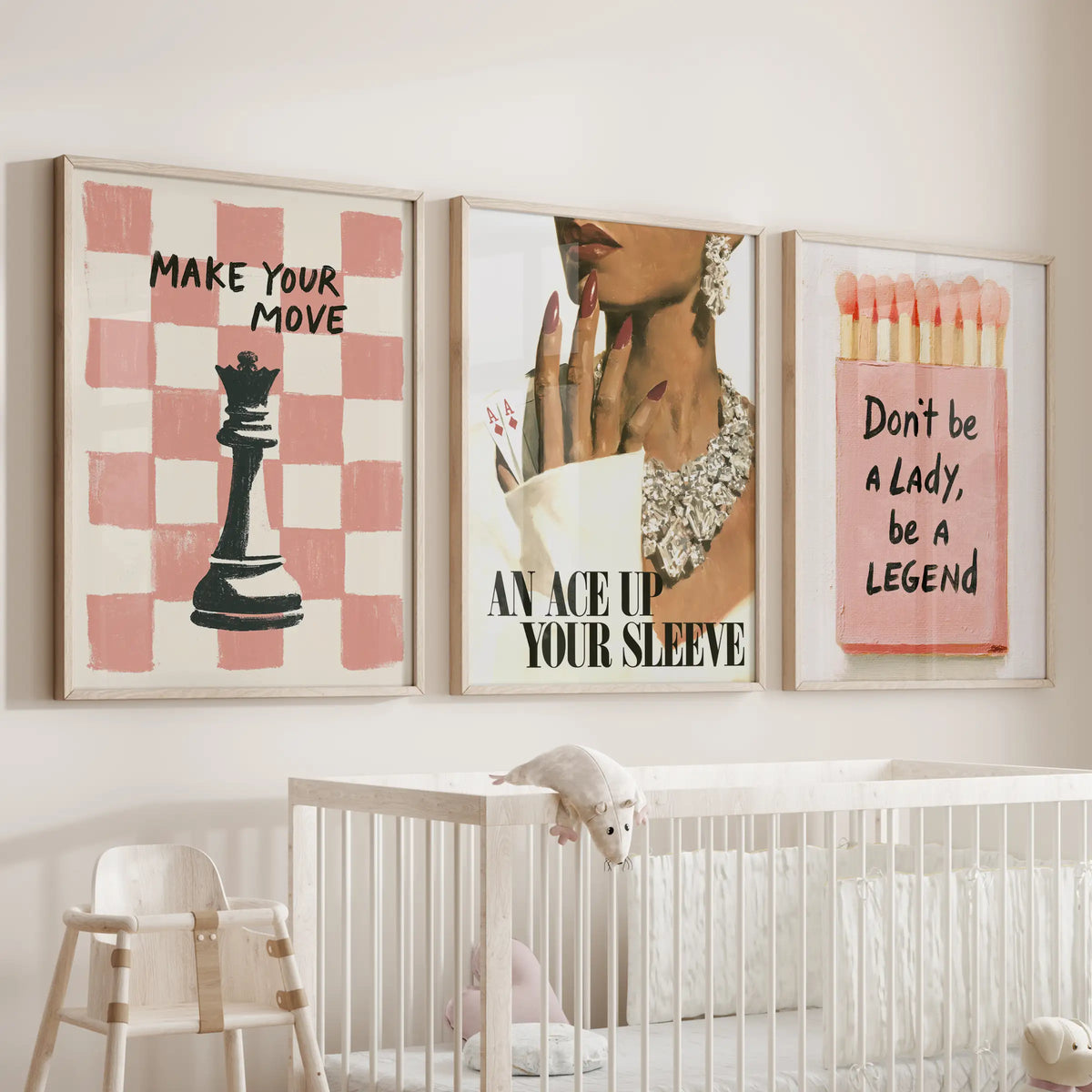 Pink matchbox three-piece gallery wall set in light oak frames, displayed over the crib in a nursery.