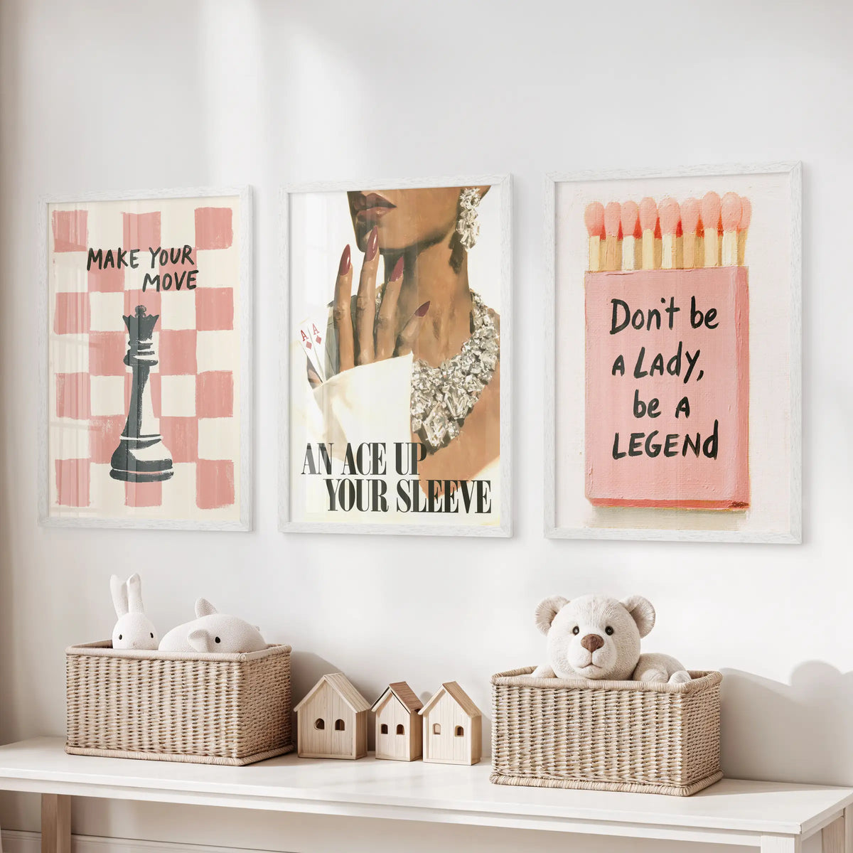 Pink matchbox wall art set of three in white frames, arranged above a toy storage bench in a kids room.