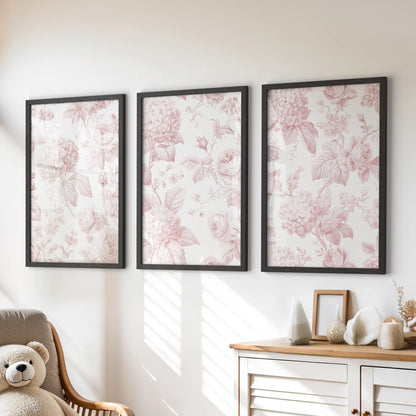 Above a dresser, three black-framed prints show pink roses and hydrangea patterns.