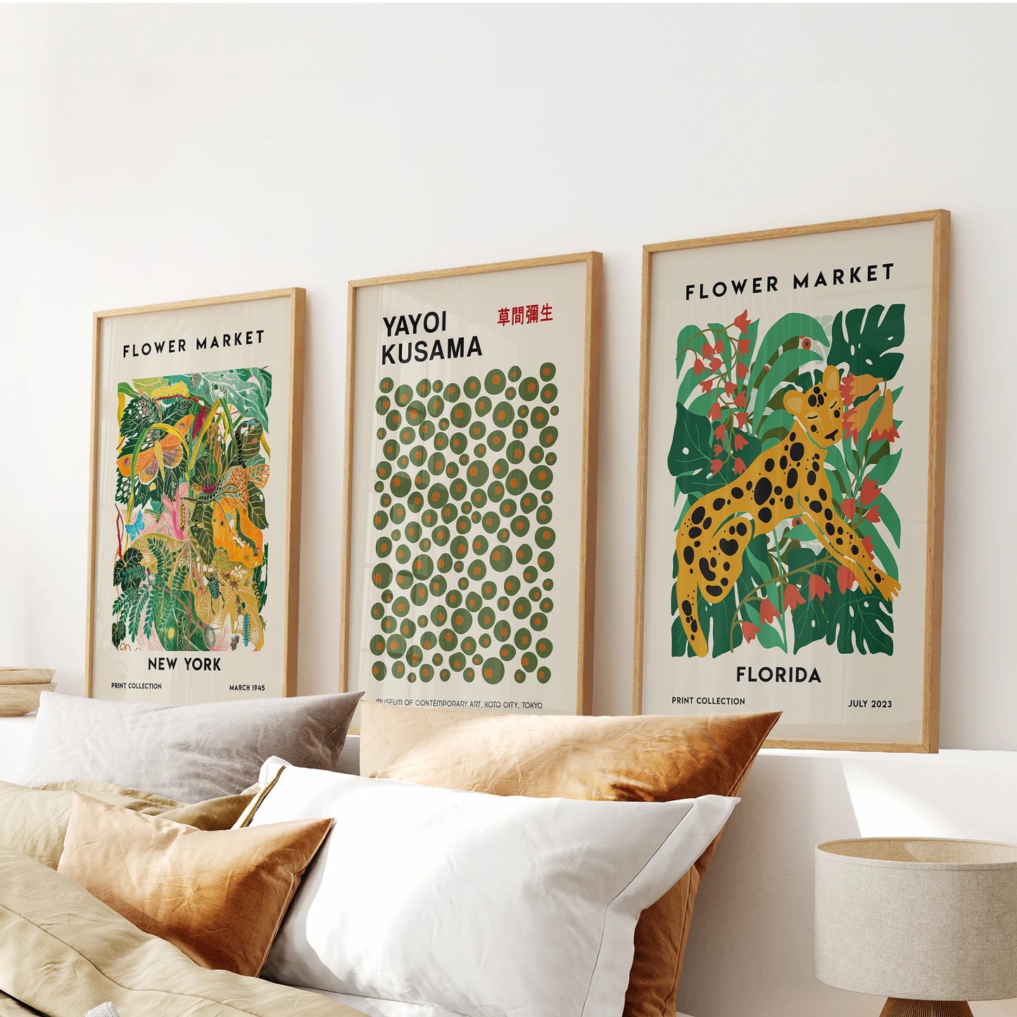 Thin wood-framed New York city wall prints, a graceful trio, anchor the space above the headboard with an urbane calm.