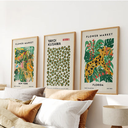 Thin wood-framed New York city wall prints, a graceful trio, anchor the space above the headboard with an urbane calm.