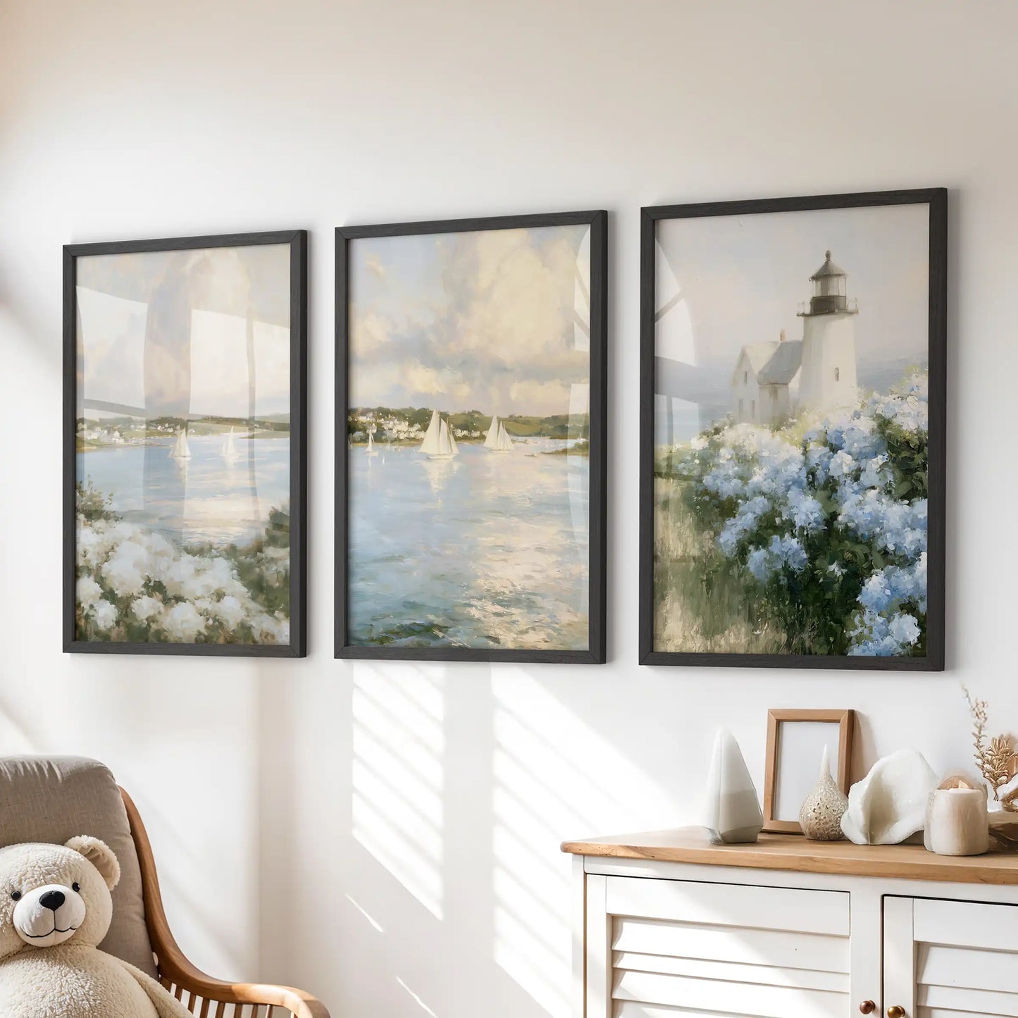 A trio of wall art prints with blue and white hydrangeas sits in black frames, adding a soft coastal touch above the dresser in a kids room.