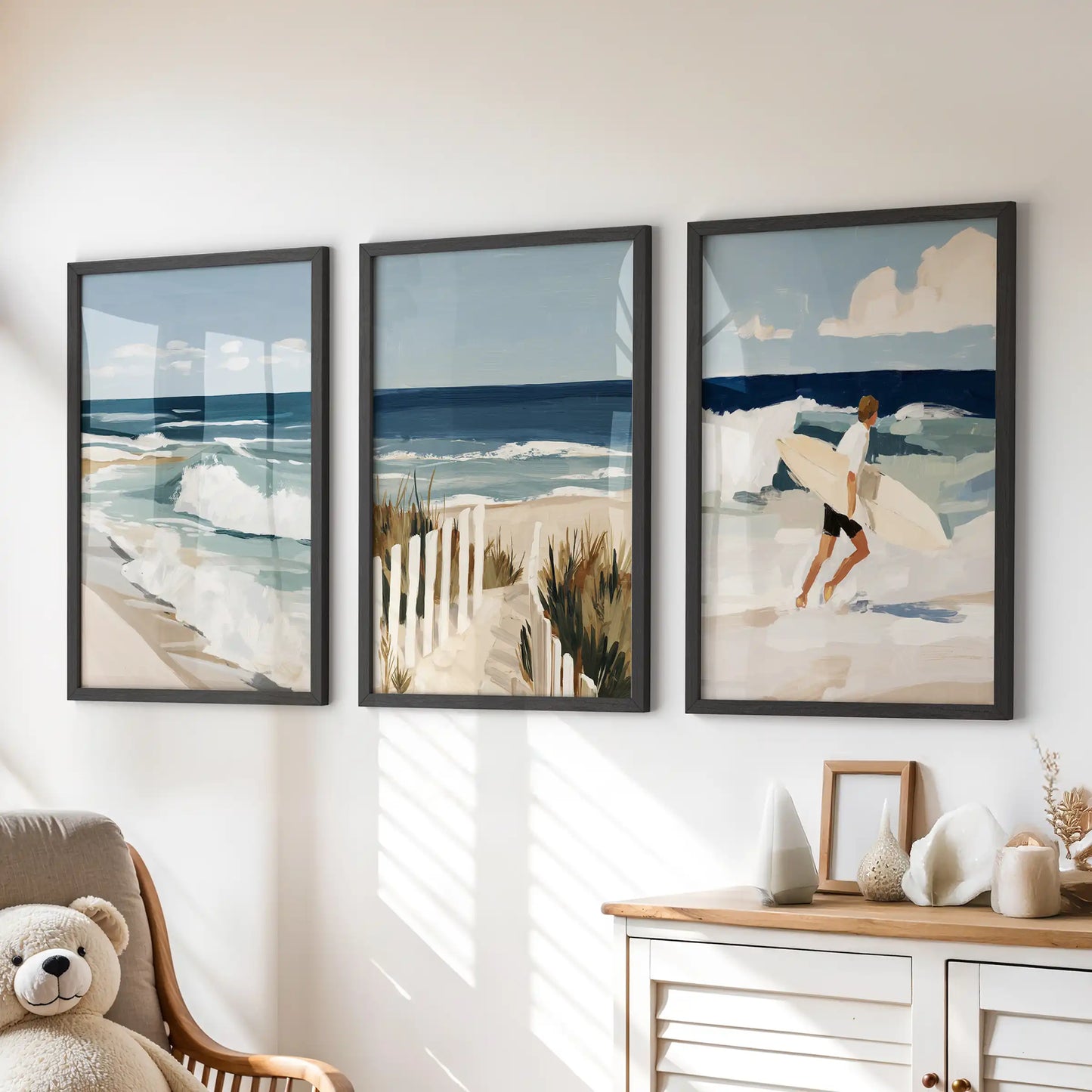 Seaside cottage wall art, 3 wall art set, settles the children's room in calm coastal tones with black frames, styled above the chest of drawers.