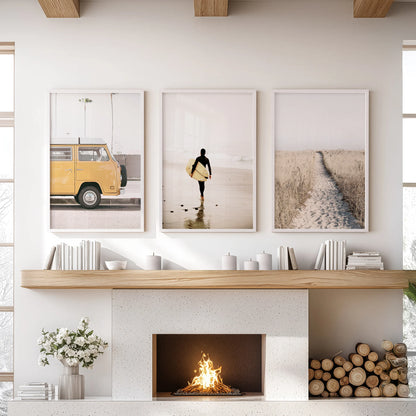 Coastal path and dunes 3 pc wall art set in a clean white frame hangs over the fireplace, giving the family room a calm shoreline feel.
