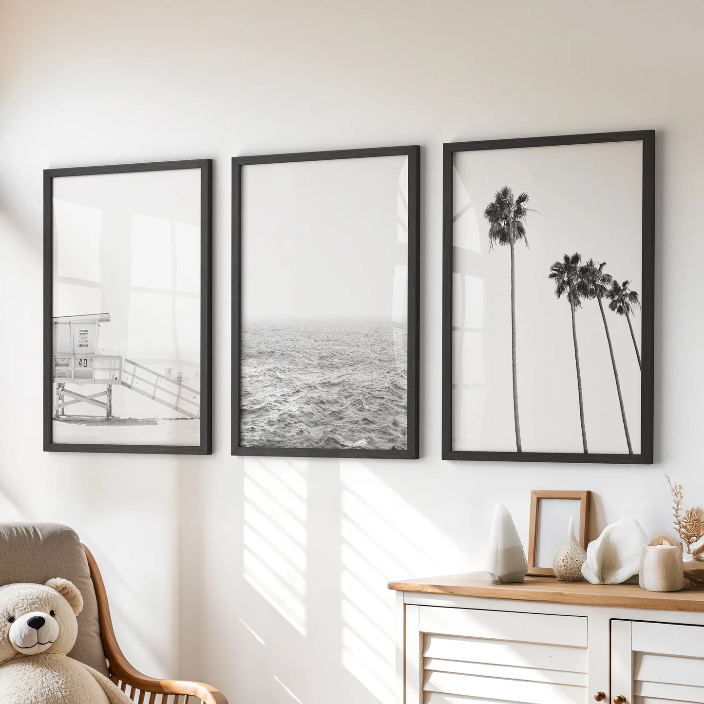 Ocean shoreline, a 3-piece wall art set, hangs as black-framed prints in the kids' room, resting above the chest of drawers with airy calm.