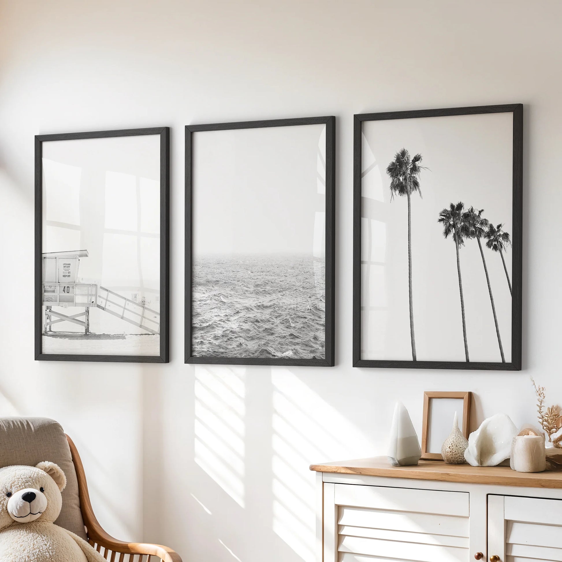 Ocean shoreline, a 3-piece wall art set, hangs as black-framed prints in the kids' room, resting above the chest of drawers with airy calm.
