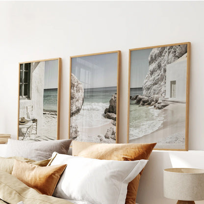 Minimalist ocean scenes, three piece artwork in light oak frames, span over the bed to keep the bedroom serene with balanced horizon and tide.