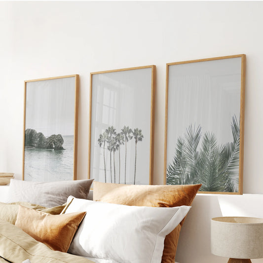 This three-piece wall décor set of palm silhouettes, framed in warm wood, aligns over the bed for a balanced, sunwashed bedroom look.
