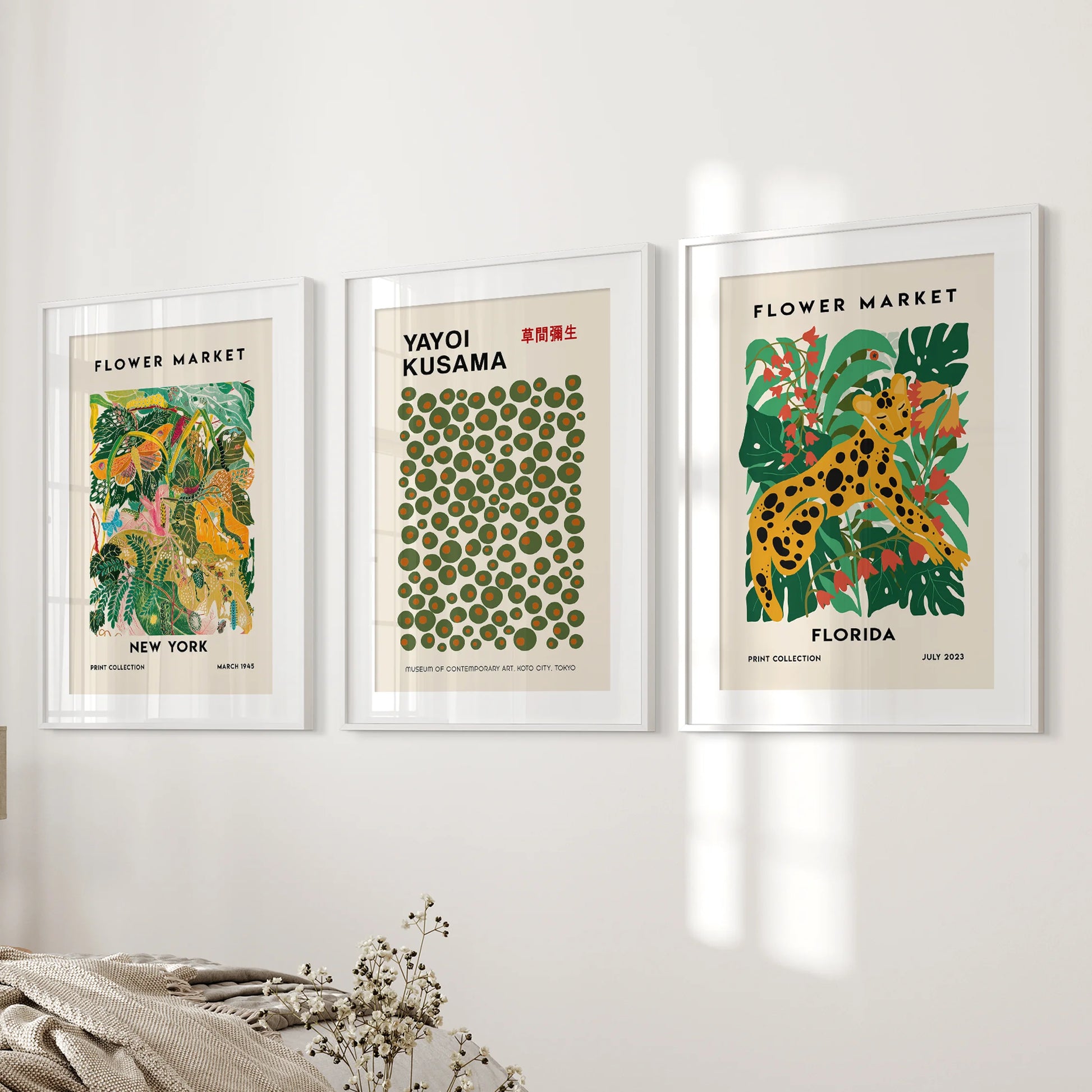 Florida abstract wall art, a set of three, brightens the bedroom next to the bed with white frames and matting that keep the colors feeling airy.