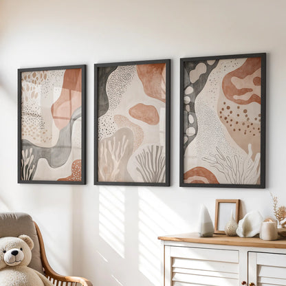 Three black-framed prints of organic mid-century forms add tidy balance above the dresser, suiting a playful kids’ room.