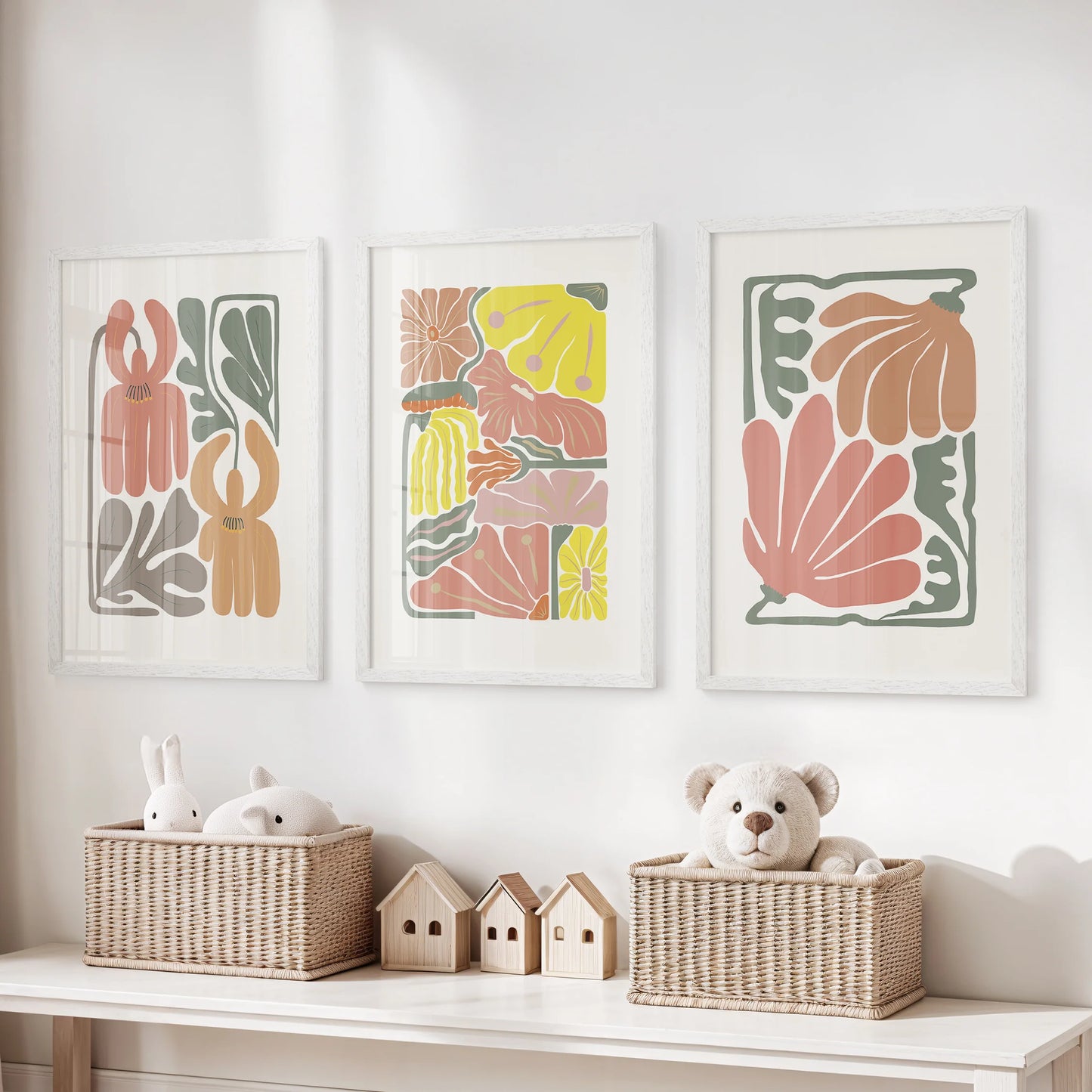 White-framed art prints, three in a set, show abstract botanicals in soft terracotta tones that bring a light, friendly texture to the playroom wall.