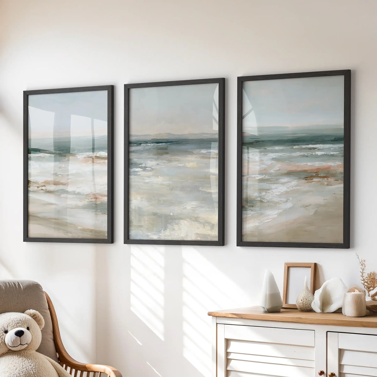 Three black-framed coastal prints make up this calm wall art set, bringing a gentle shoreline accent above the dresser in the kids room.