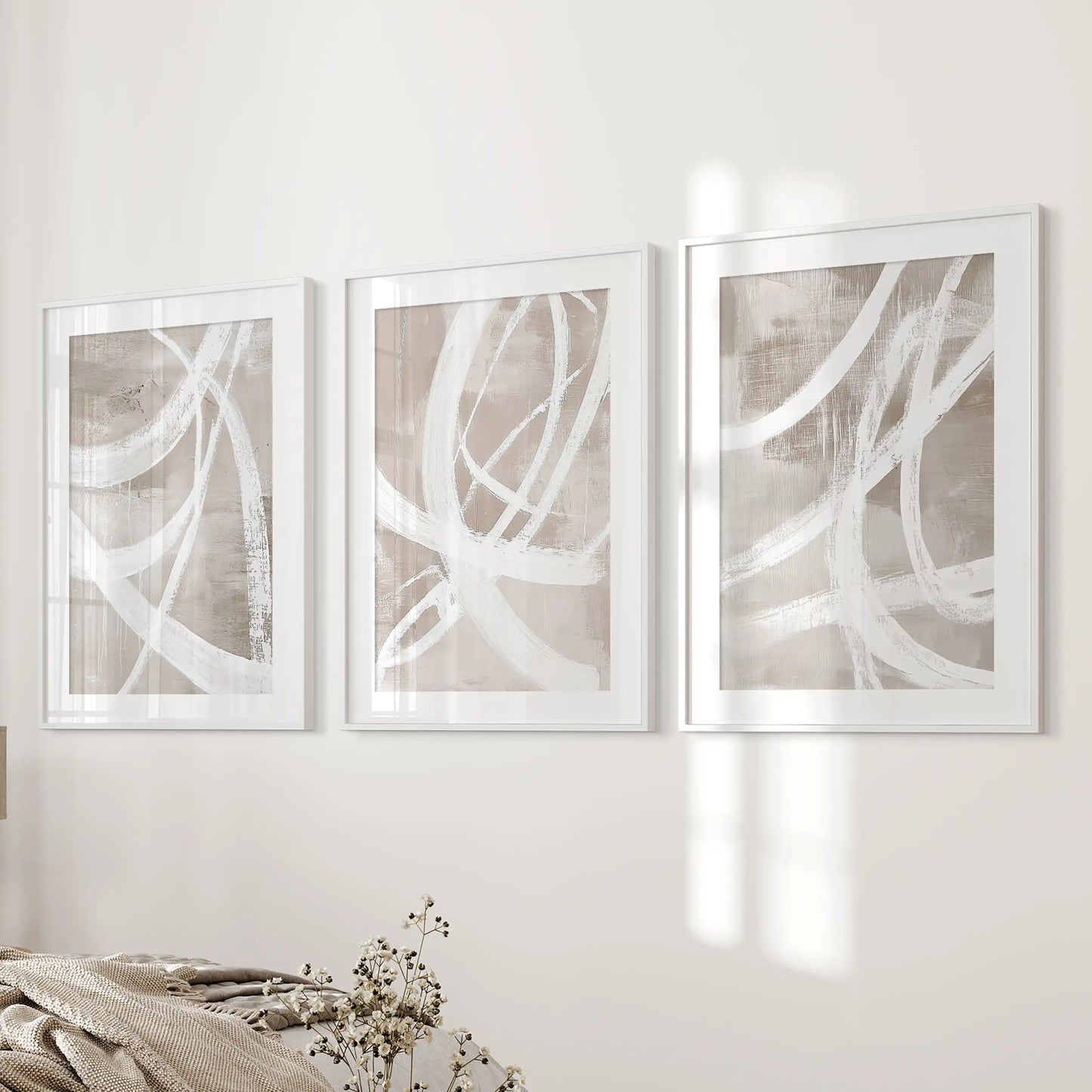 Contemporary compositions wall art, a three-piece wall hanging in white matted frames, rests beside the bed wall for a serene bedroom.