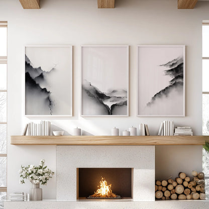 Set of three wall prints showing monochrome abstract scenery keeps the family room balanced over the hearth in white-framed focus.