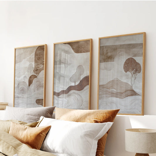 Earth-toned abstract landscapes three-piece artwork, as wood-framed prints, crowns the bedroom headboard and layers warmth into the wall.