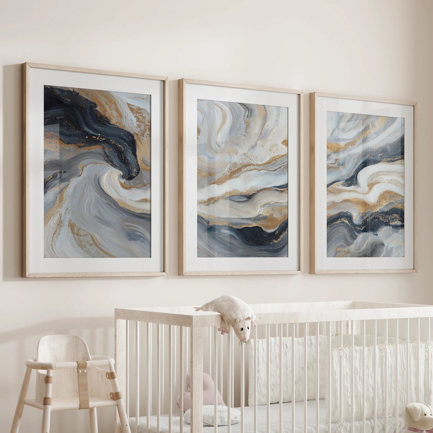 Navy blue brush stroke abstracts, a three-piece wall decor set, are wood framed with matting and placed above the crib in the nursery.