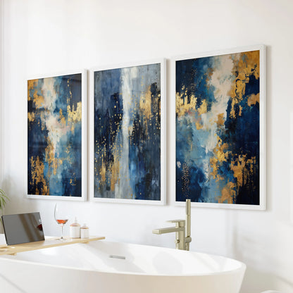 Minimalist blue and gold art set in a white-framed three-print collection rests as wall art over the soaking tub, bringing calm texture to the bathroom.
