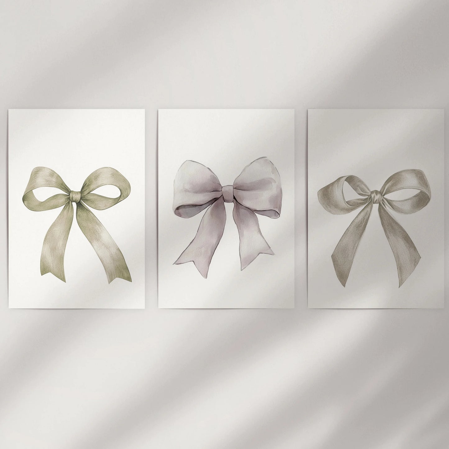Bow motif wall art, a three-piece print set, dresses a bare wall with unframed sheets that showcase delicate neutral ribbons and airy negative space.