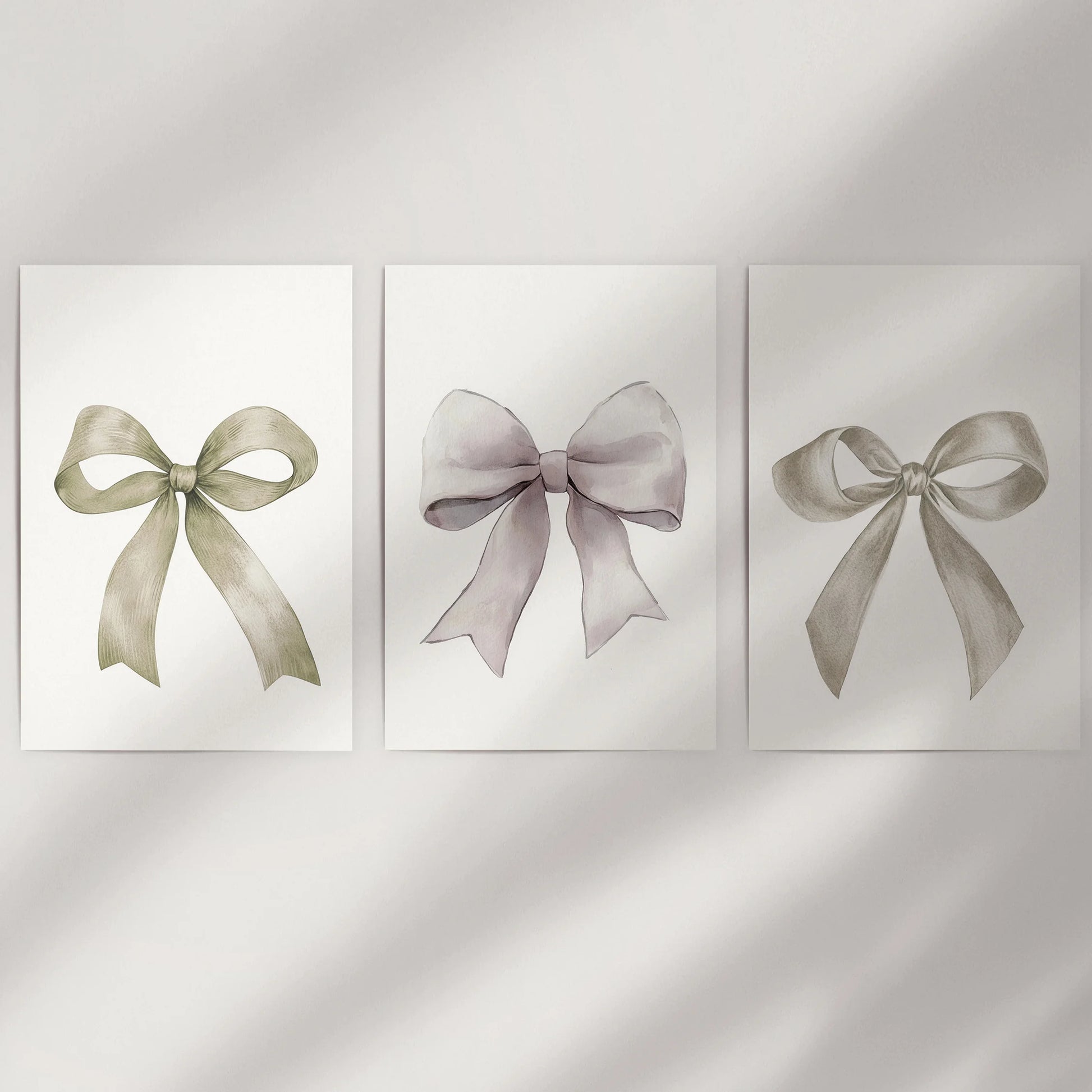 Bow motif wall art, a three-piece print set, dresses a bare wall with unframed sheets that showcase delicate neutral ribbons and airy negative space.