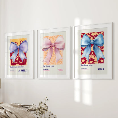 Set of 3 coquette bow prints with mats and white frames forms a graceful column beside the bedroom bed for a clean, feminine look.
