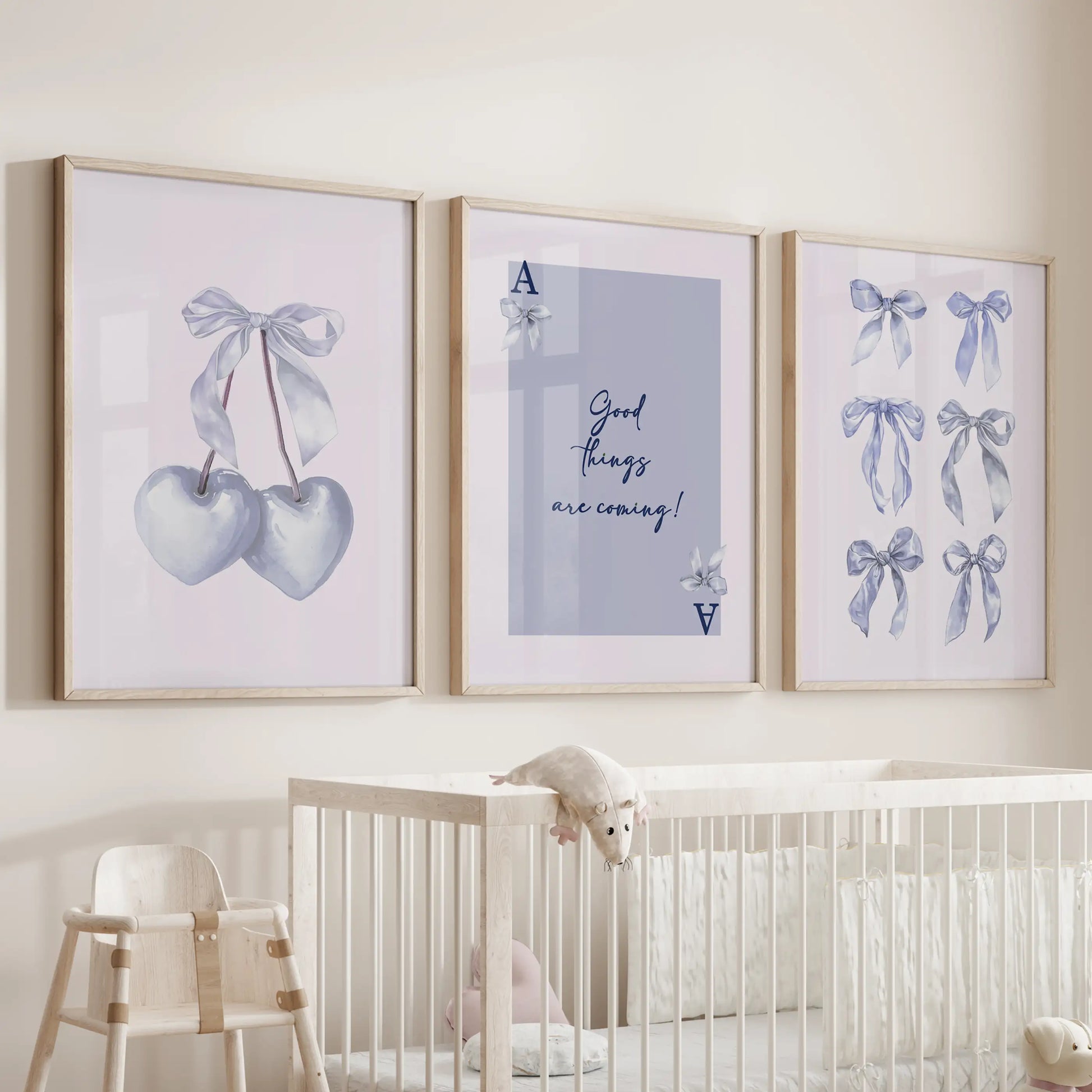 Light blue bow aesthetic wall art, three-poster set, rests in wood-framed prints above the bassinet, lending a gentle, pretty hush to the infant room.