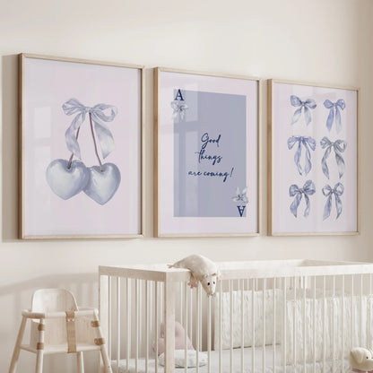 Light blue bow aesthetic wall art, three-poster set, rests in wood-framed prints above the bassinet, lending a gentle, pretty hush to the infant room.