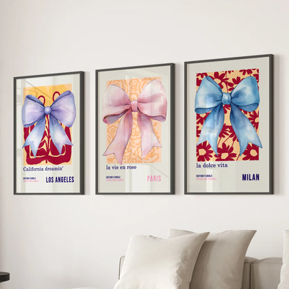 Three black-framed wall prints showing watercolor bows line the lounge neatly behind the couch, giving the space a balanced, artful feel.