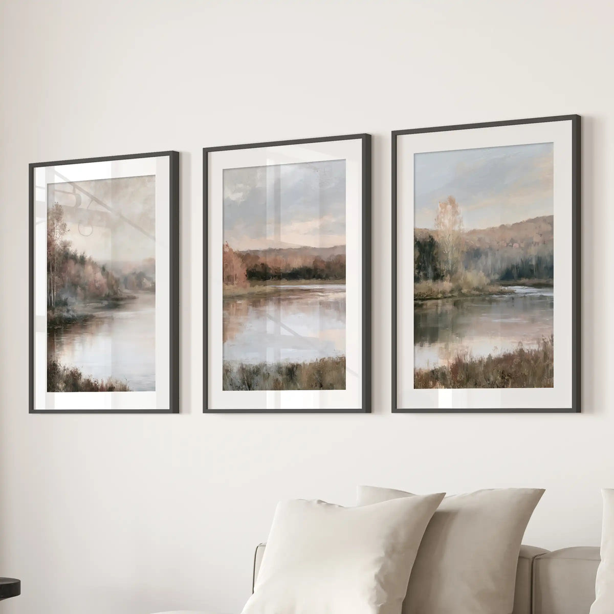 Lakeside forest scenes in a three-print wall art set, black framed with mats, span over the living room sectional for a calm, cottage focal point.