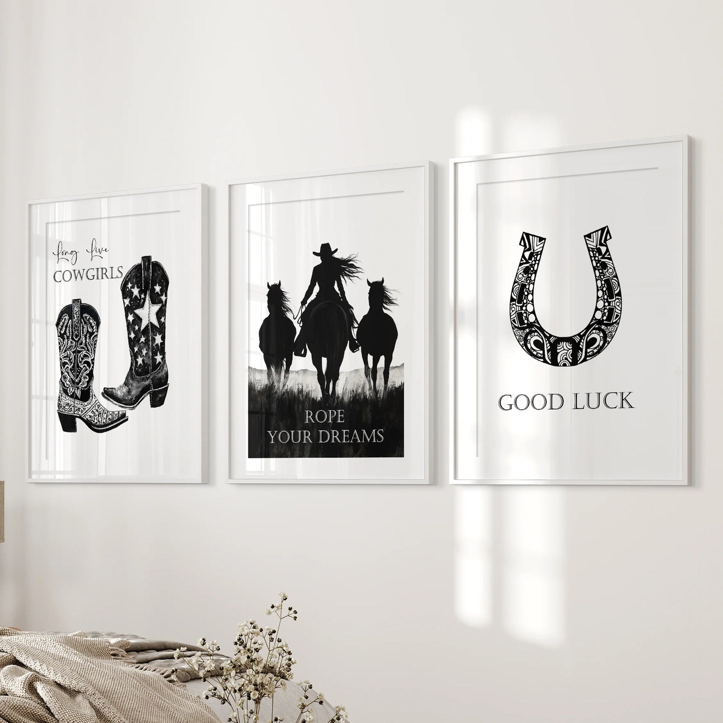 Cowboy-boot artwork in a three-print bundle with white mats warms the bedroom wall near the bed with soft, trail-worn character.