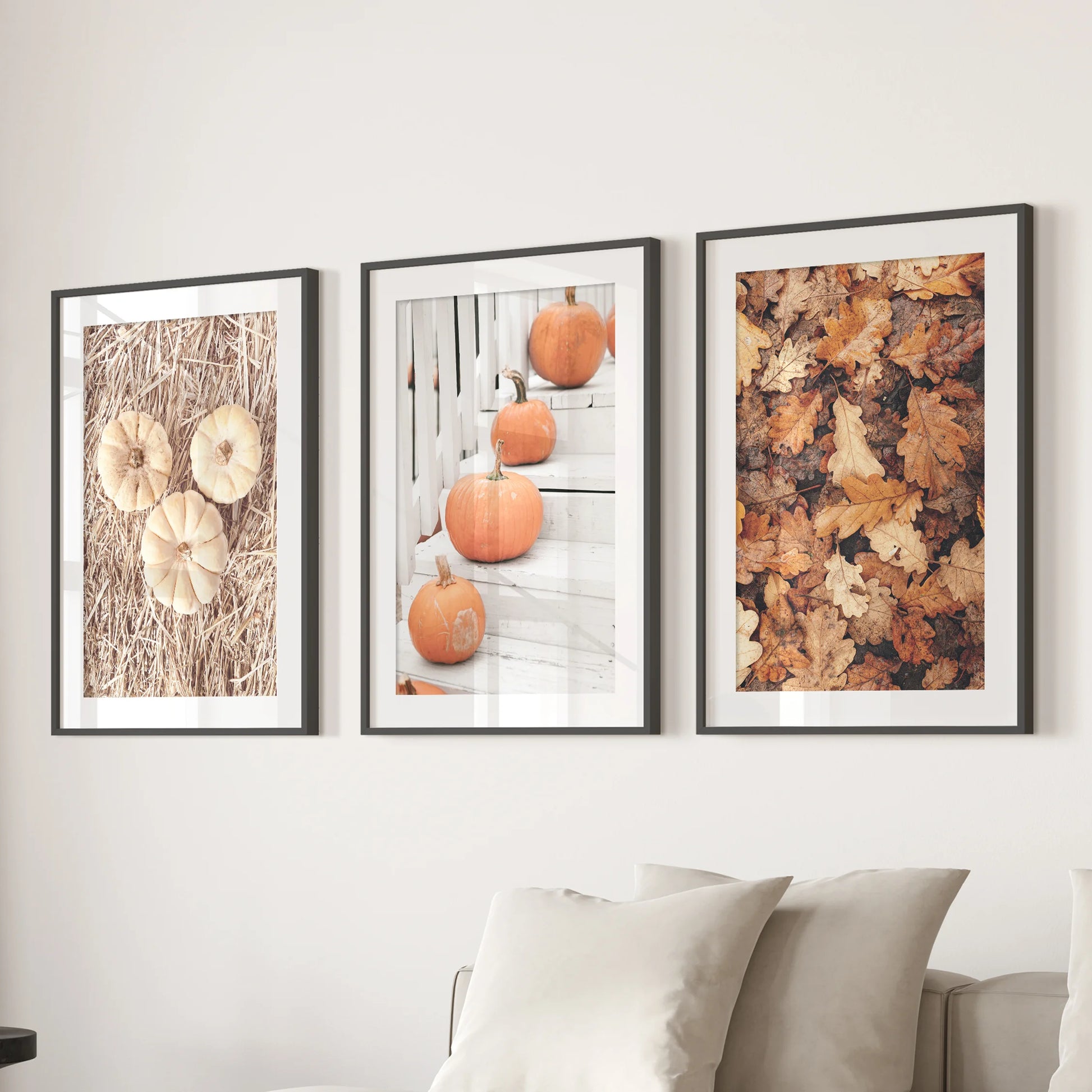 A set of three pumpkin wall prints with black matted frames floats above the living-room sofa, lending a crisp gallery look.