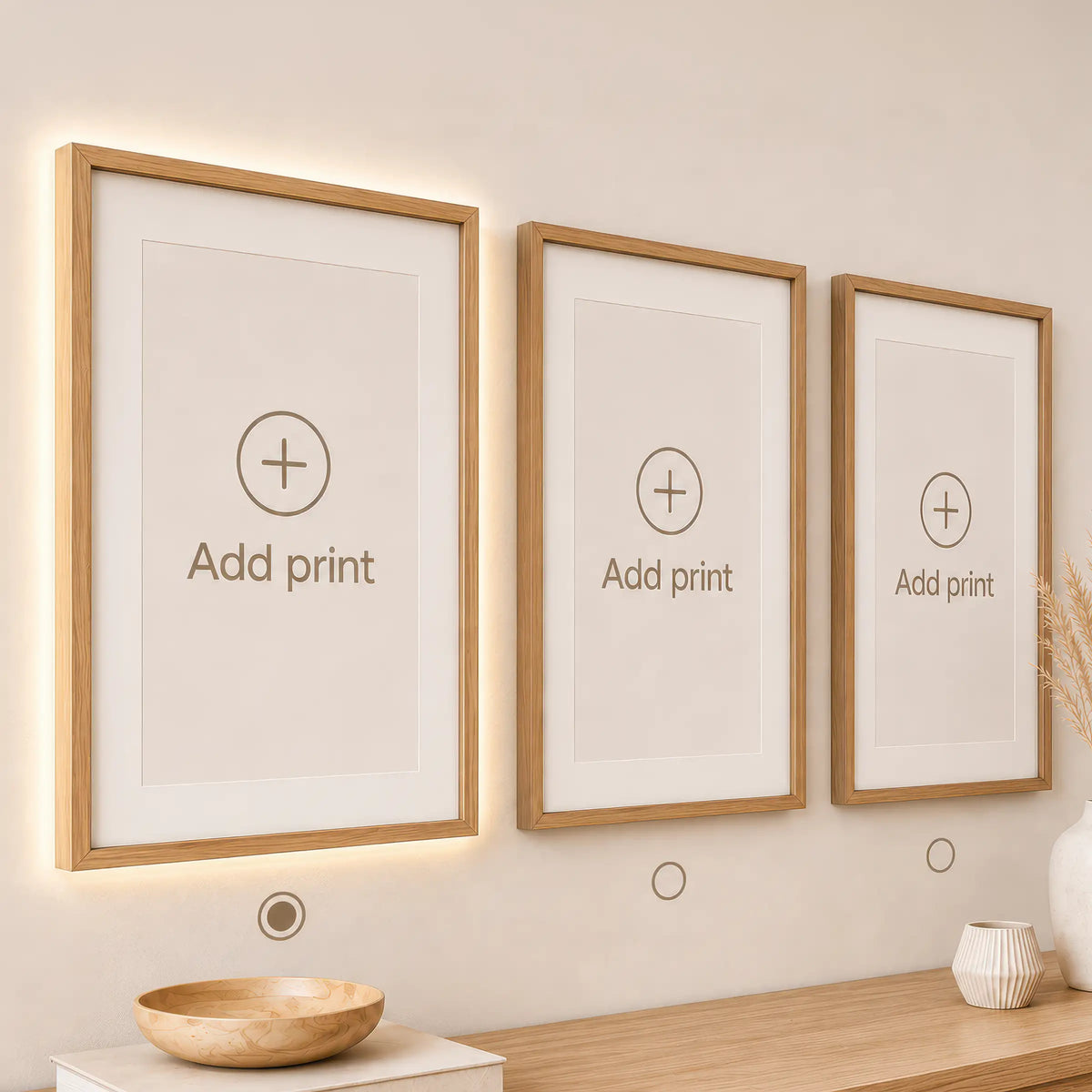 Three wooden picture frames on a wall with 'Add print' text, light fixture below.