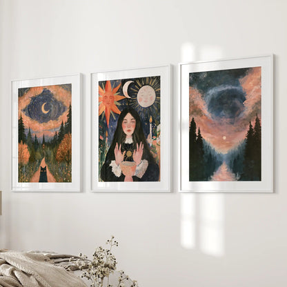 Three witchy forest landscape posters in white frames with crisp mats hang beside the bed, forming a softly gothic bedroom vignette.