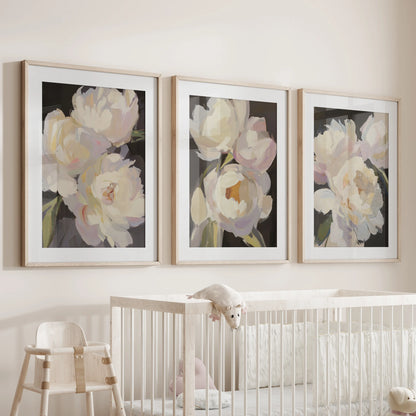 Pink and white peonies, a 3-pc wall art set, nestle above the nursery bassinet in oak frames with mats, a tender vintage touch for quiet hours.