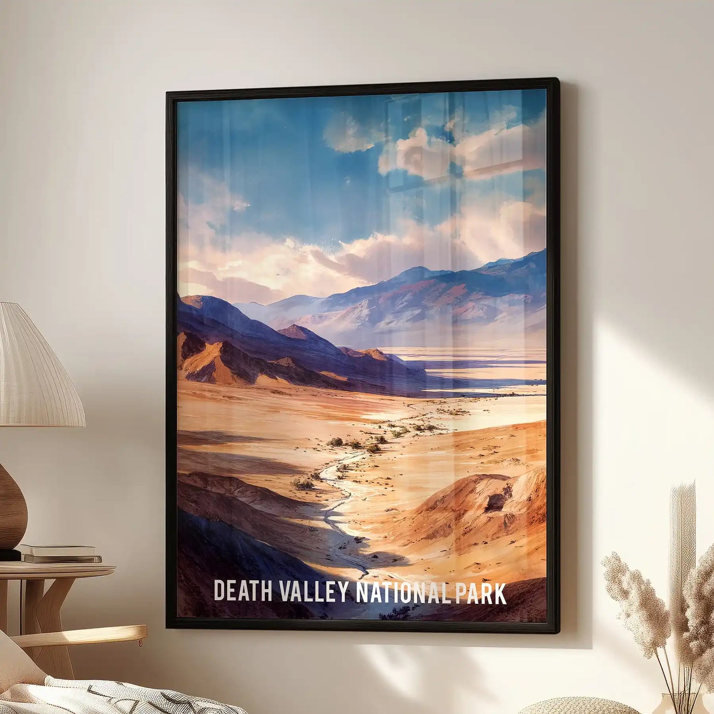 A black-framed landscape art print of Death Valley National Park hangs beside a reading chair, giving the family room an easy, travel-minded calm.