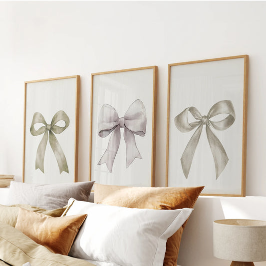 Minimalist ribbon art, a 3-piece wall art set, crowns the headboard area in warm wooden frames, pairing creamy bows with natural texture for a cozy finish.