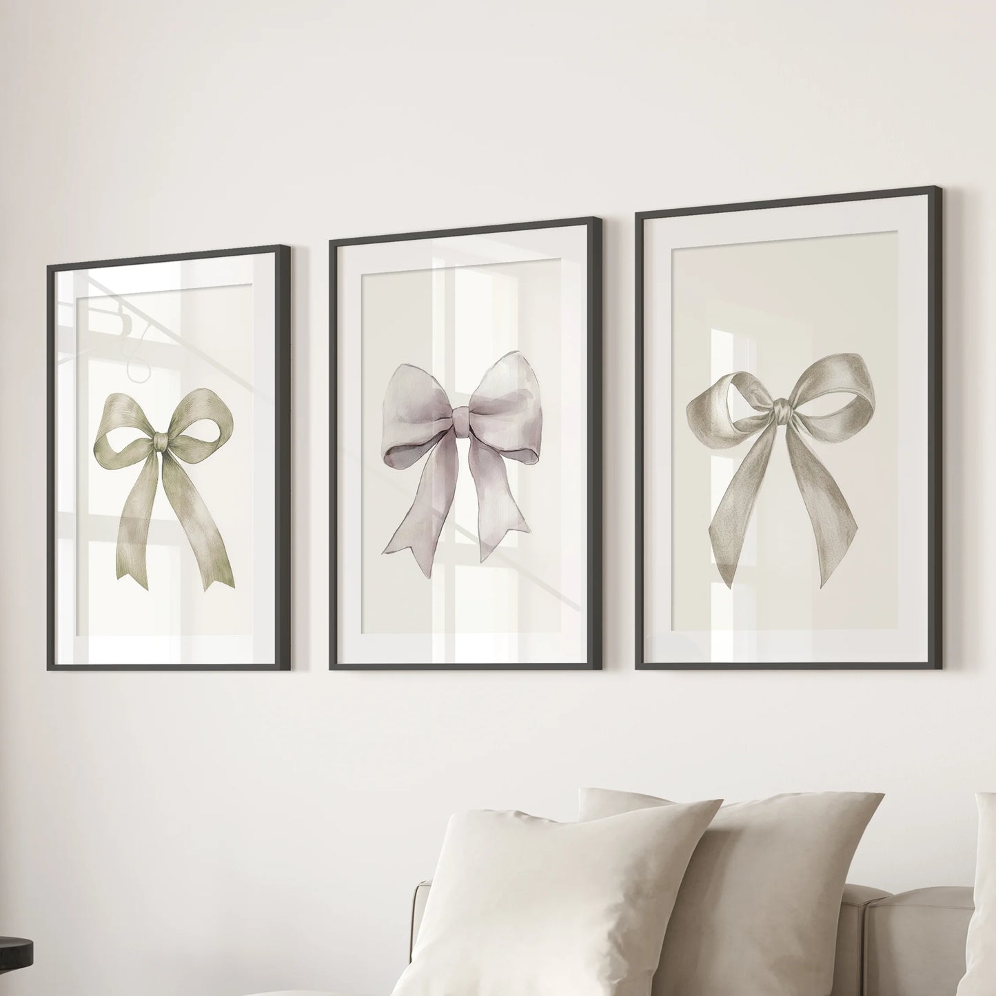 A 3-piece bow print wall set anchors the sitting-room sectional, each piece in a black-matted frame sharpening the cream ribbon sketches.