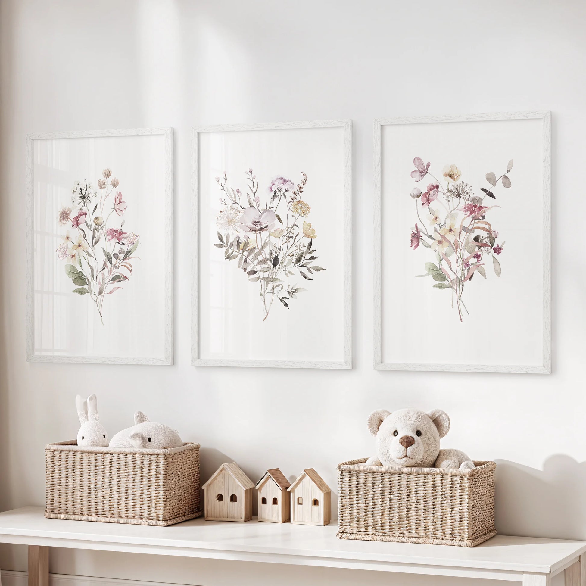 A whimsical set of three white-framed plant illustrations adds a gentle green touch to the kids’ playroom wall.