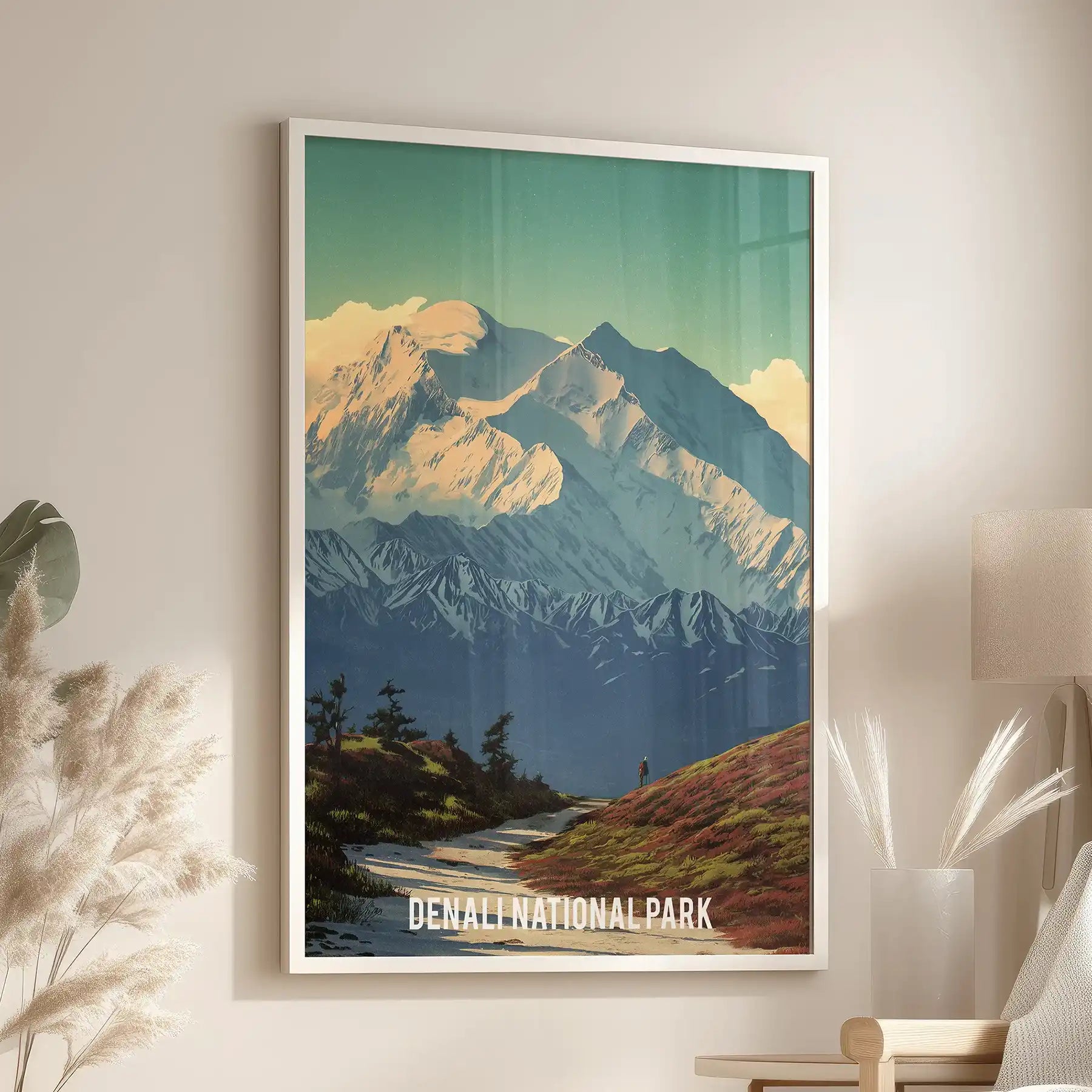 Retro-style Denali wall art poster shows icy peaks in soft vintage tones, hung above the window-side chair in a tidy white frame.