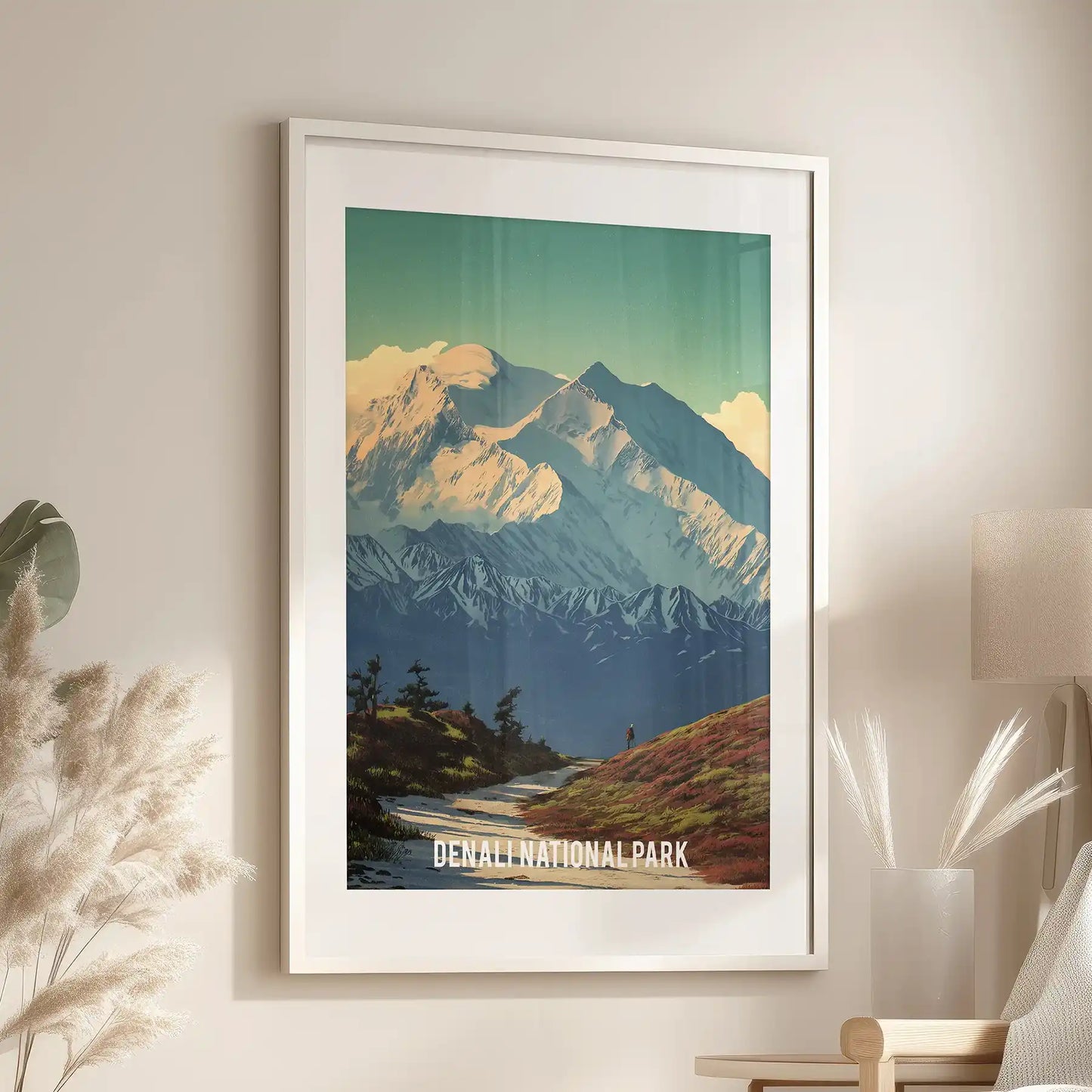 Hiking landscape in Alaska home wall art brings Denali’s vast slopes to the sitting room, mounted above the accent chair in a white frame with a crisp mat.