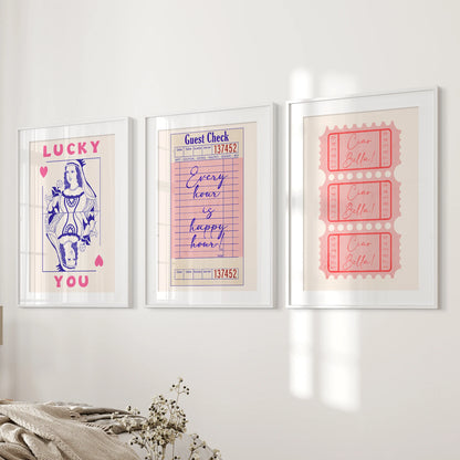 Guest check, ticket stub, and playing card art, a 3-piece wall set, features white-matted frames for a tidy bedroom display on the wall beside the bed.