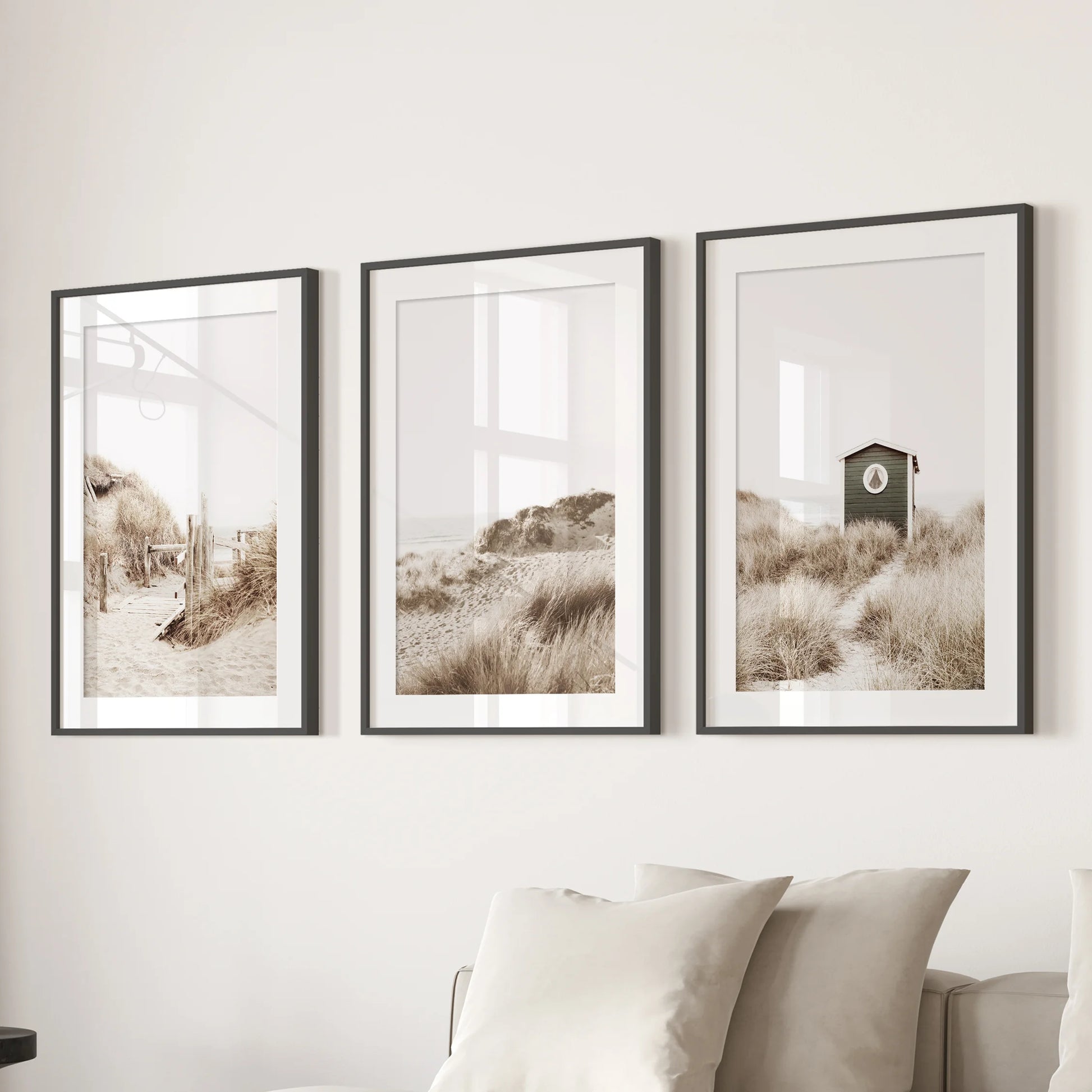 Pampas grass 3-piece art set in black frames with mats styles the sitting room above the couch, adding airy texture and warm neutral tones.