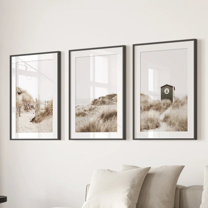 Pampas grass 3-piece art set in black frames with mats styles the sitting room above the couch, adding airy texture and warm neutral tones.