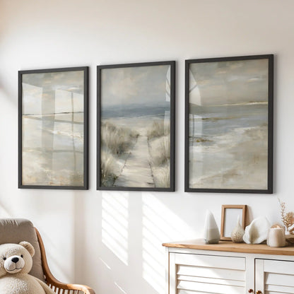 Black-framed wall art of soft sand textures, a set of three prints, floats above the chest of drawers for a gentle coastal mood in the children’s room.