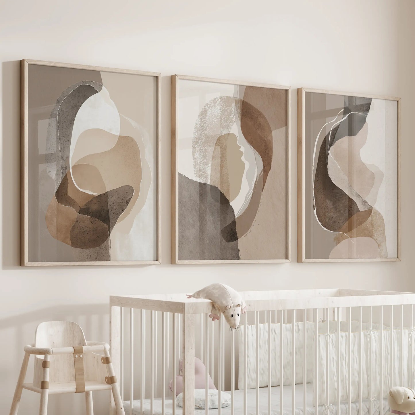 Beige and brown minimalist art 3-piece picture set, in natural wood frames, rests above the crib to soothe a baby room with gentle earth hues.