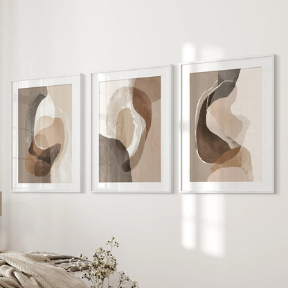 Boho abstract shapes gallery wall set of 3 art prints, matted in white frames, lines the bedroom wall beside the bed for a serene, modern accent.