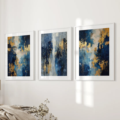 A gallery wall set of three white-framed navy-and-gold prints lines the bedroom wall next to the bed, adding refined modern balance.