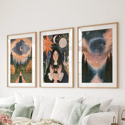 The witchy forest landscape wall art trio, in matted natural wood frames, lines the space behind the sitting-room couch for a grounded, moody backdrop.